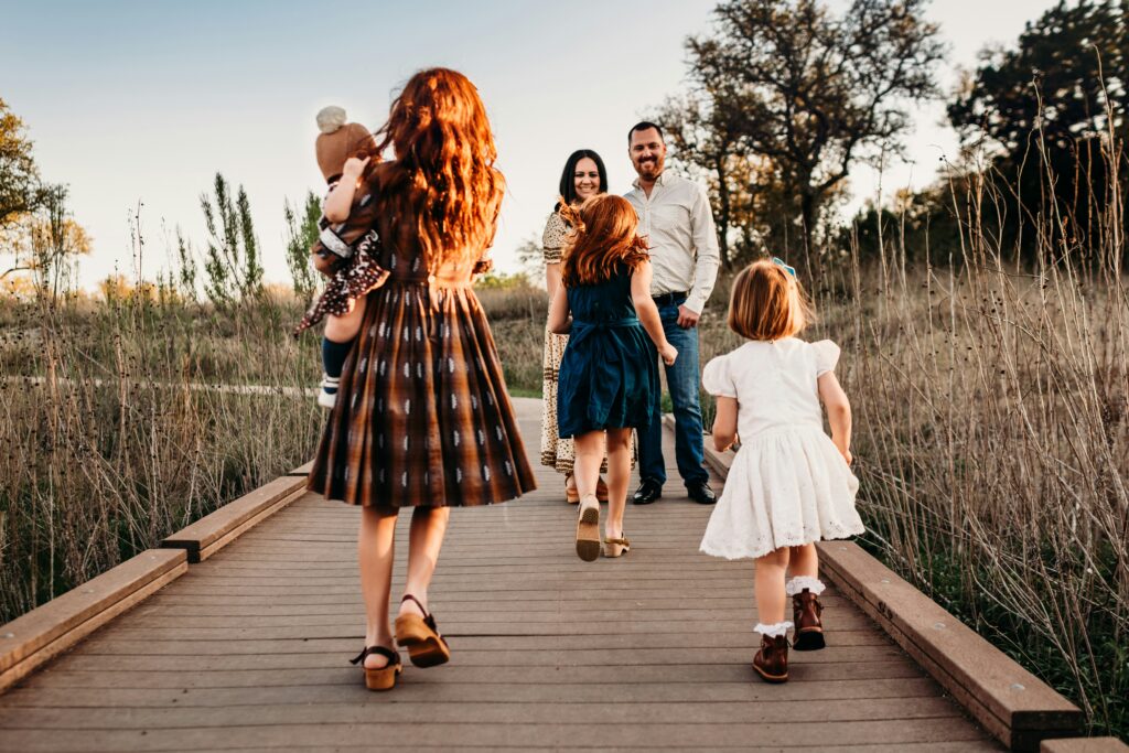 Family on bridge in nature. 